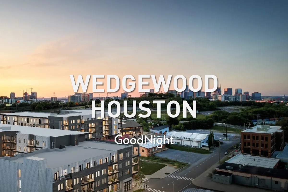 Modern apartment buildings frame a city skyline at sunset, with a green landscape in the foreground. The scene is welcoming and vibrant, emphasizing neighborhood appeal and the connection between home and city life.