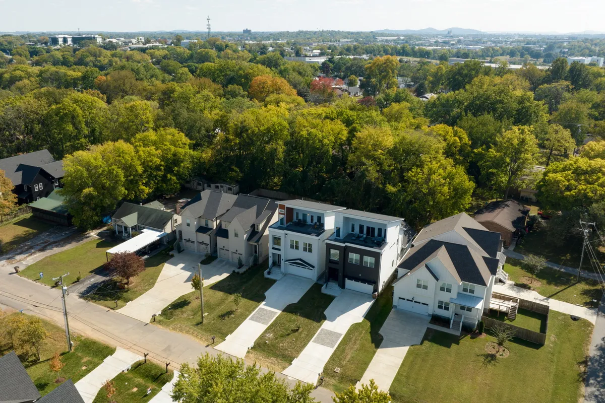 A welcoming neighborhood scene with modern houses, lush greenery, and spacious driveways designed for gatherings. The image evokes community, safety, and the potential for backyard fun or pet-friendly activities.